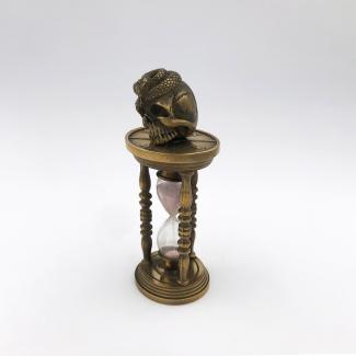 Bronze hourglass topped by a vanity