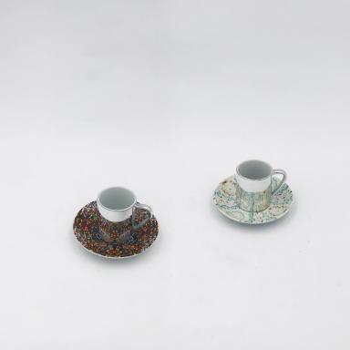 Two anamorphic cups by Damien Hirst