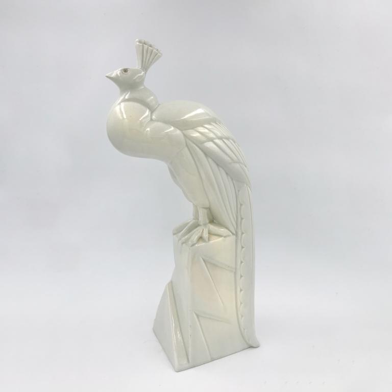 Art Deco peacock, cracked white earthenware sculpture